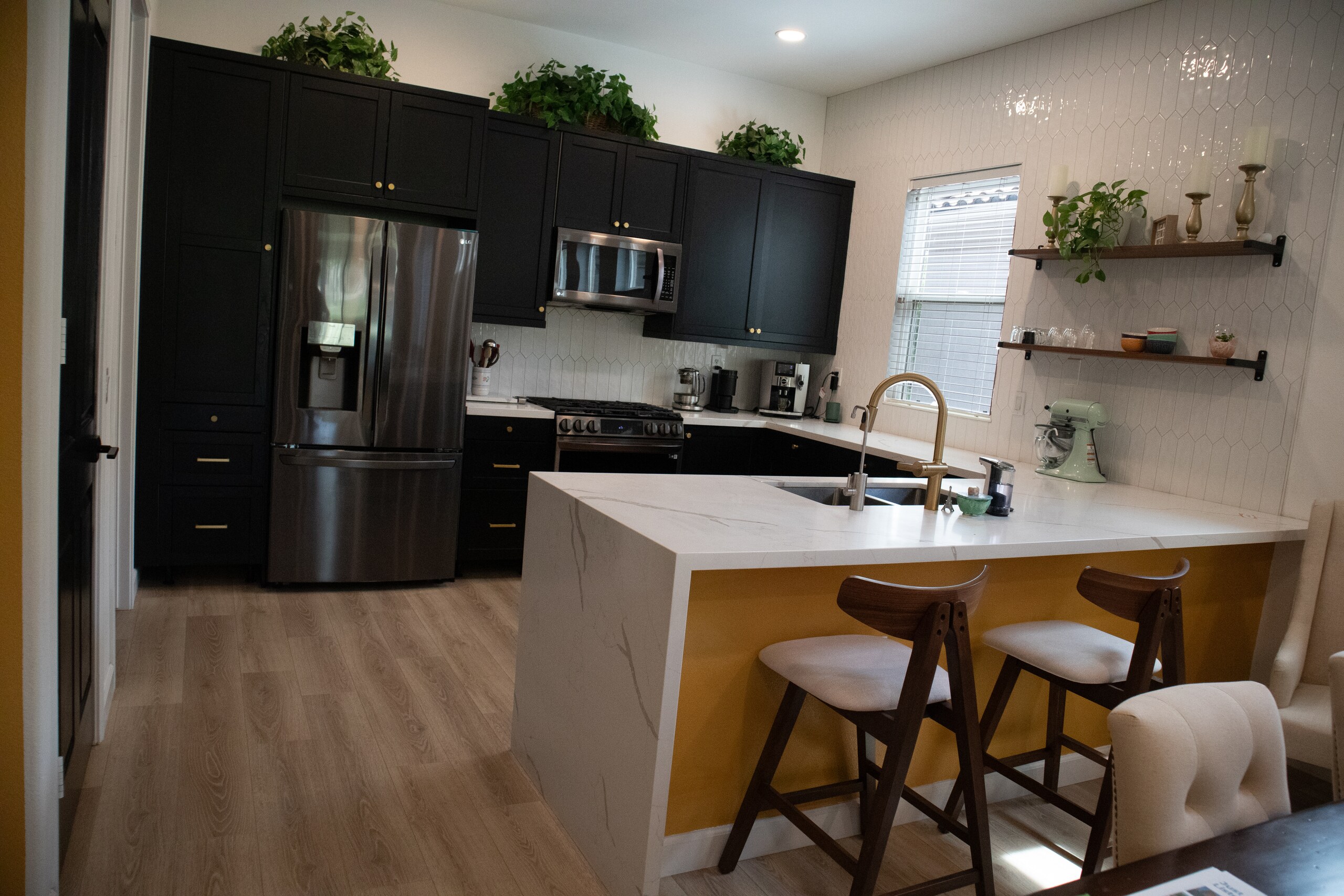 Expanded remodeled kitchen with quartz counters and stainless appliances